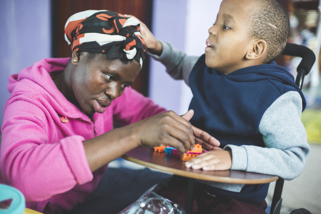 lady teaching child how to play with puzzles